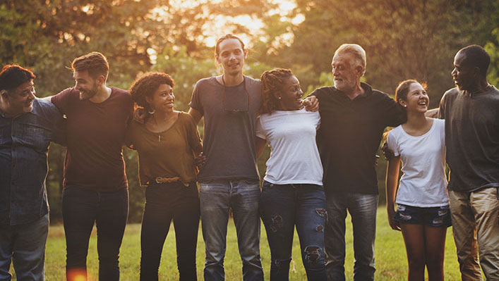 A group of people from different ages and ethnicities gathered on a sunny day