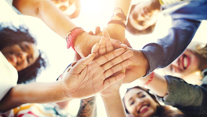 A group of peoples' hands coming together as a team